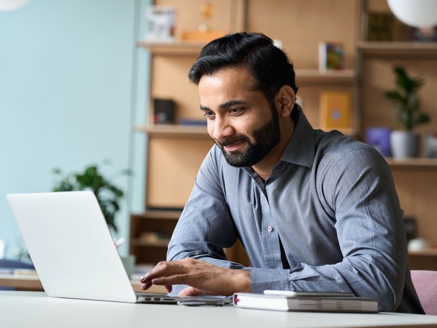 Man working on a laptop in a home office